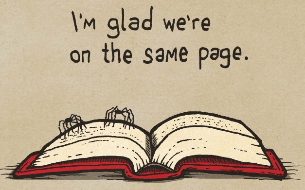 Two spiders standing on an open book. The caption reads "I'm glad we're on the same page."